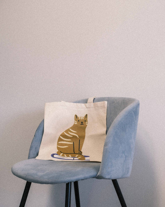 Cat Sitting on Book Organic Tote Bag